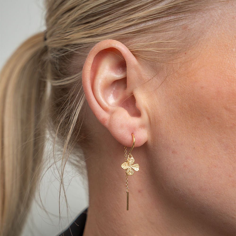 Christina Long Four Leaf Clover øreringe i forgyldt sølv med ørekrog båret på model
